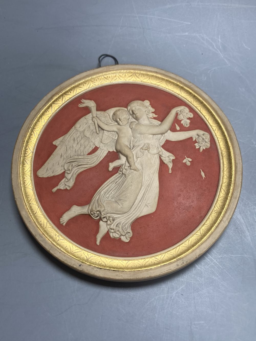 A pair of P. Ipsen Kjobenhavn Eneret relief moulded roundels, depicting night and day, 13cm